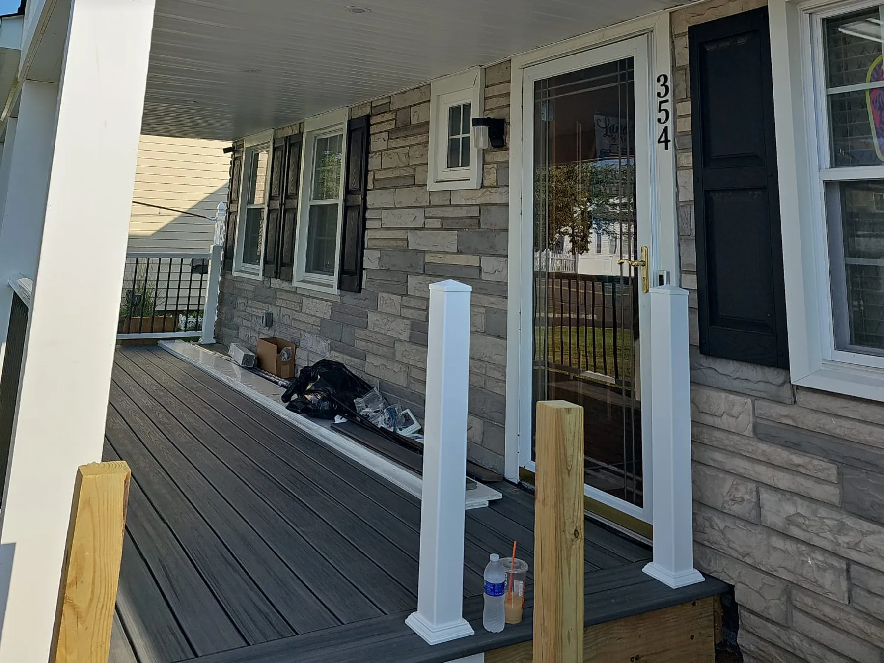 Completed gutter installation on a stone-accented home entrance