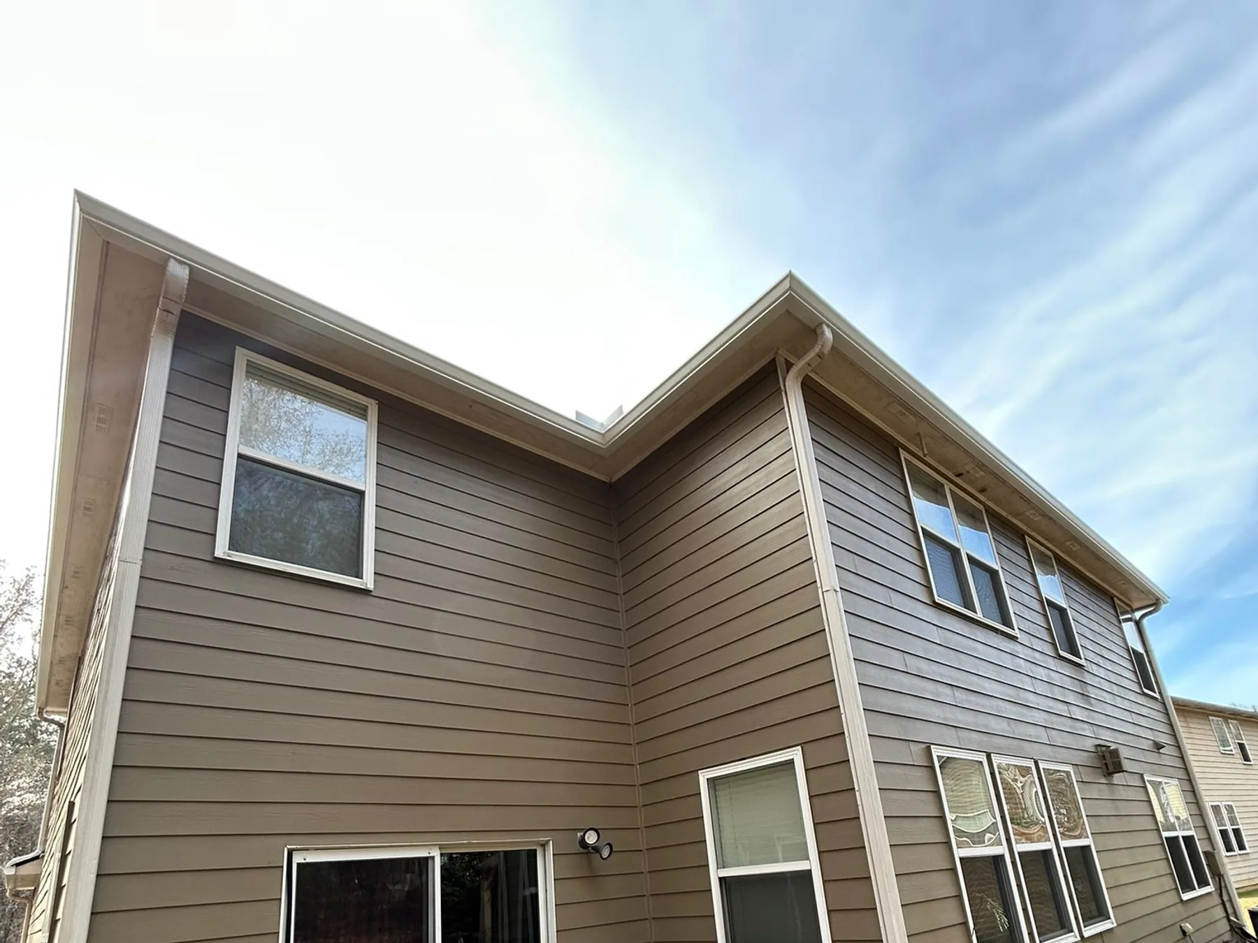 Completed gutter installation on a modern two-story home