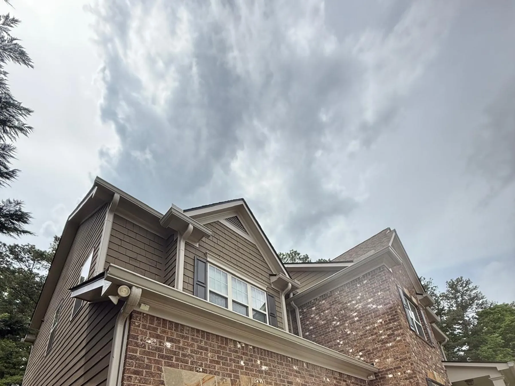 Finished gutter installation on a craftsman-style home with a three-car garage
